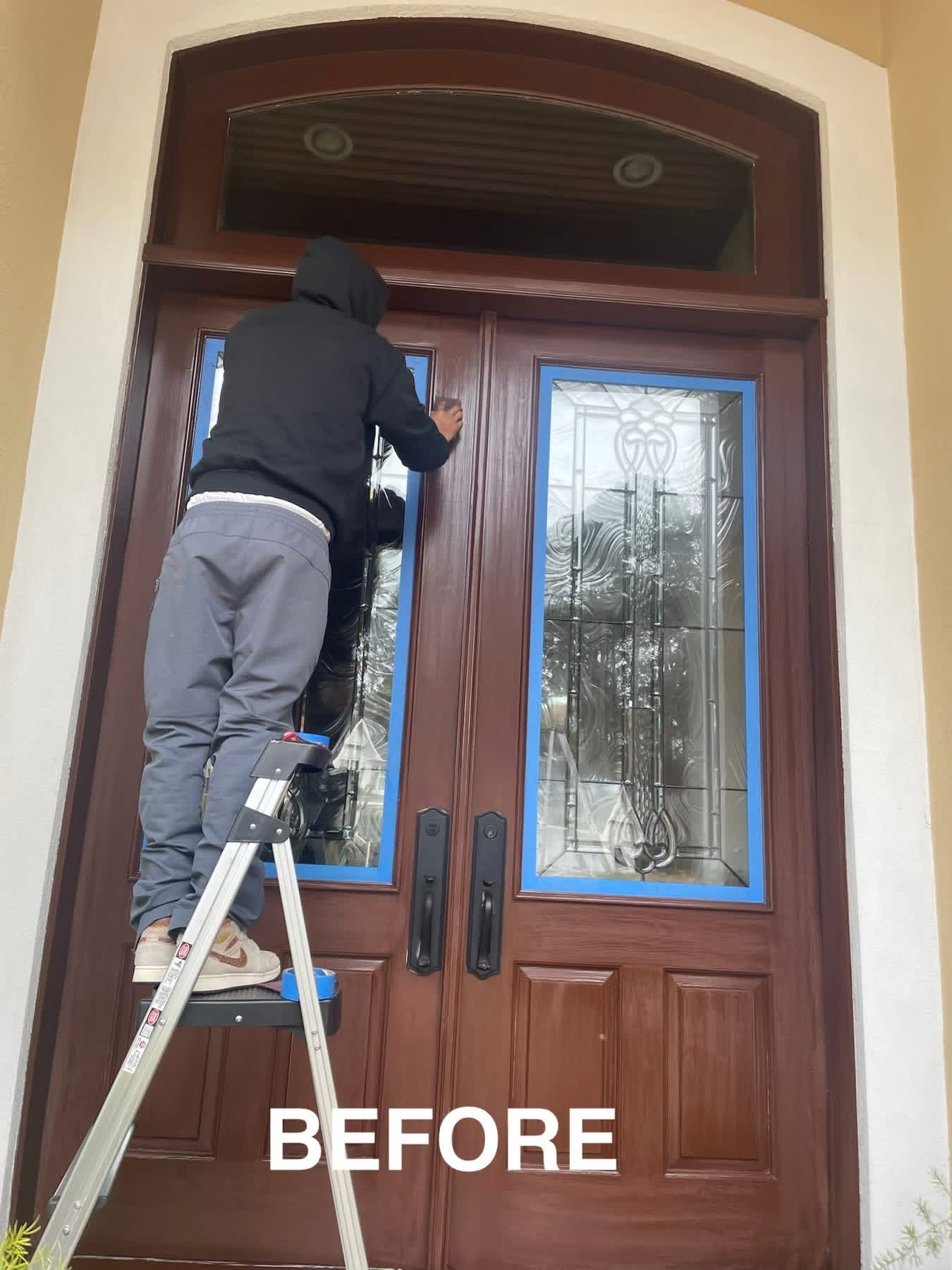 Front door prepped with painter's tape before refinish